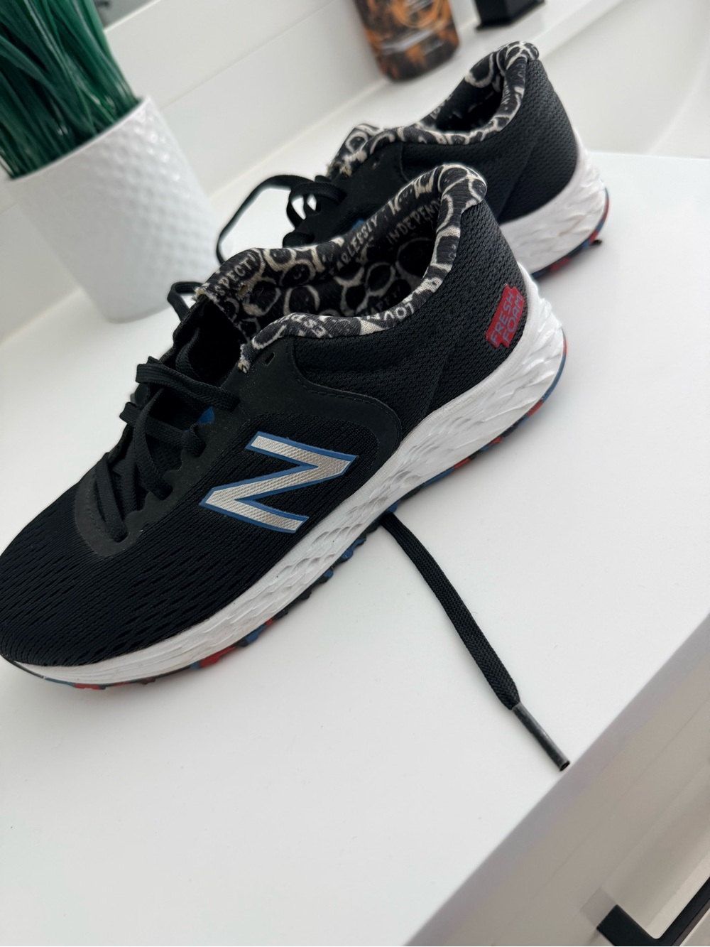 New Balance Kids Black Sneakers with Blue and White Logo